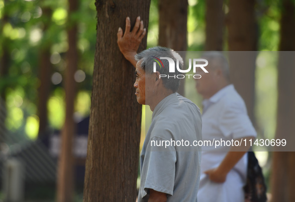 Senior citizens are relaxing at a park in Fuyang, China, on July 22, 2024. 