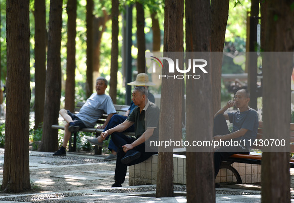 Senior citizens are relaxing at a park in Fuyang, China, on July 22, 2024. 