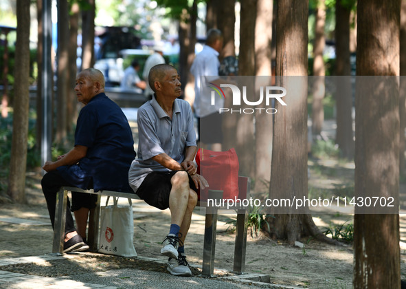 Senior citizens are relaxing at a park in Fuyang, China, on July 22, 2024. 