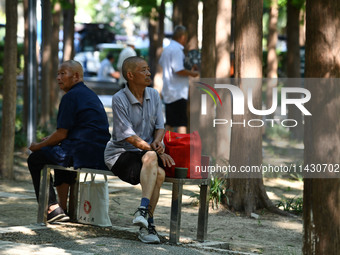 Senior citizens are relaxing at a park in Fuyang, China, on July 22, 2024. (