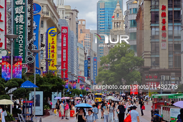 Tourists are traveling along the Nanjing Road pedestrian street in Shanghai, China, on July 24, 2024. 