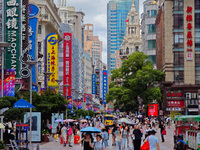 Tourists are traveling along the Nanjing Road pedestrian street in Shanghai, China, on July 24, 2024. (