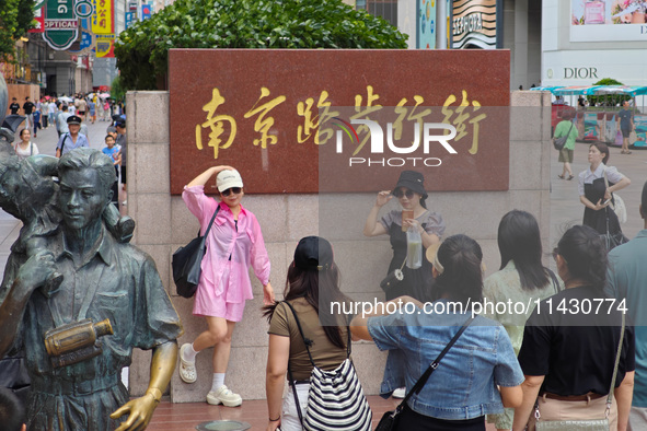 Tourists are traveling along the Nanjing Road pedestrian street in Shanghai, China, on July 24, 2024. 