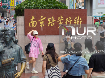 Tourists are traveling along the Nanjing Road pedestrian street in Shanghai, China, on July 24, 2024. (