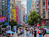 Tourists are traveling along the Nanjing Road pedestrian street in Shanghai, China, on July 24, 2024. (