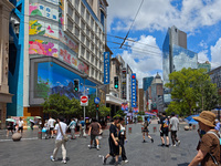 Tourists are traveling along the Nanjing Road pedestrian street in Shanghai, China, on July 24, 2024. (