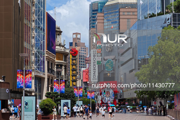 Tourists are traveling along the Nanjing Road pedestrian street in Shanghai, China, on July 24, 2024. 