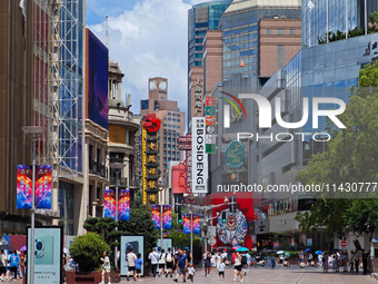 Tourists are traveling along the Nanjing Road pedestrian street in Shanghai, China, on July 24, 2024. (