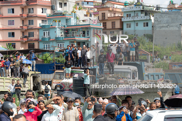 Spectators are gathering around to see the wreckage of the Saurya Airlines plane that crashed at Tribhuvan International Airport (TIA) in Ka...