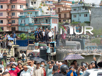 Spectators are gathering around to see the wreckage of the Saurya Airlines plane that crashed at Tribhuvan International Airport (TIA) in Ka...