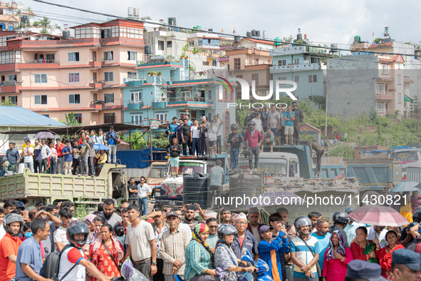 Spectators are gathering around to see the wreckage of the Saurya Airlines plane that crashed at Tribhuvan International Airport (TIA) in Ka...