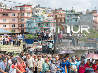 Spectators are gathering around to see the wreckage of the Saurya Airlines plane that crashed at Tribhuvan International Airport (TIA) in Ka...