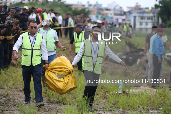 Officials from the Civil Aviation Authority of Nepal (CAAN) are retrieving the black box of the passenger aircraft of Saurya Airlines that c...