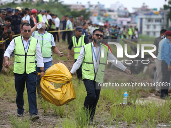 Officials from the Civil Aviation Authority of Nepal (CAAN) are retrieving the black box of the passenger aircraft of Saurya Airlines that c...