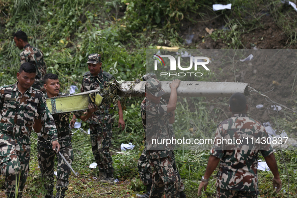 Rescuers from Nepal's security agencies are salvaging the remains of a passenger aircraft of Saurya Airlines that crashed at Tribhuvan Inter...