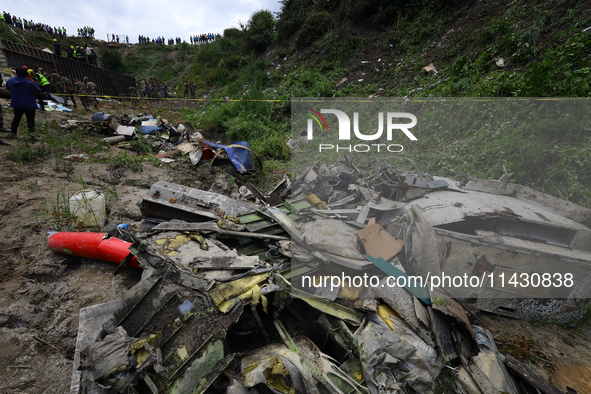 Rescuers from Nepal's security agencies are salvaging the remains of a passenger aircraft of Saurya Airlines that crashed at Tribhuvan Inter...