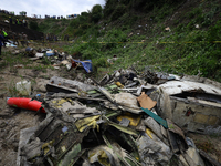 Rescuers from Nepal's security agencies are salvaging the remains of a passenger aircraft of Saurya Airlines that crashed at Tribhuvan Inter...