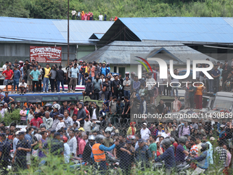 Locals are gathering outside the Tribhuvan International Airport after a passenger aircraft is crashing in Kathmandu, Nepal, on July 24, 202...