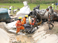 Rescuers from Nepal's security agencies are salvaging the remains of a passenger aircraft of Saurya Airlines that crashed at Tribhuvan Inter...