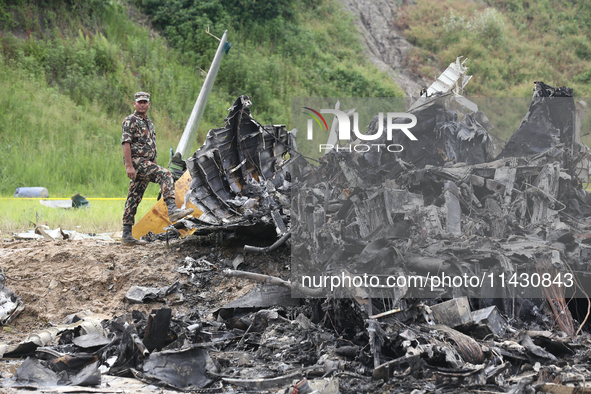 Rescuers from Nepal's security agencies are salvaging the remains of a passenger aircraft of Saurya Airlines that crashed at Tribhuvan Inter...