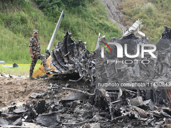 Rescuers from Nepal's security agencies are salvaging the remains of a passenger aircraft of Saurya Airlines that crashed at Tribhuvan Inter...