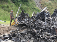 Rescuers from Nepal's security agencies are salvaging the remains of a passenger aircraft of Saurya Airlines that crashed at Tribhuvan Inter...