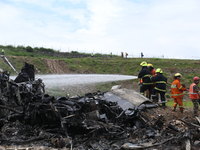 Rescuers from Nepal's security agencies are salvaging the remains of a passenger aircraft of Saurya Airlines that crashed at Tribhuvan Inter...