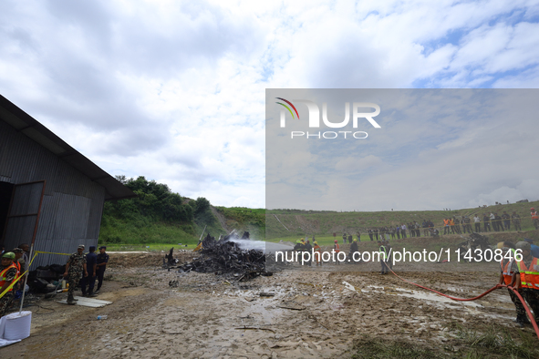 Rescuers from Nepal's security agencies are salvaging the remains of a passenger aircraft of Saurya Airlines that crashed at Tribhuvan Inter...