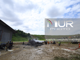 Rescuers from Nepal's security agencies are salvaging the remains of a passenger aircraft of Saurya Airlines that crashed at Tribhuvan Inter...