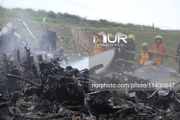 Rescuers from Nepal's security agencies are salvaging the remains of a passenger aircraft of Saurya Airlines that crashed at Tribhuvan Inter...