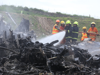 Rescuers from Nepal's security agencies are salvaging the remains of a passenger aircraft of Saurya Airlines that crashed at Tribhuvan Inter...