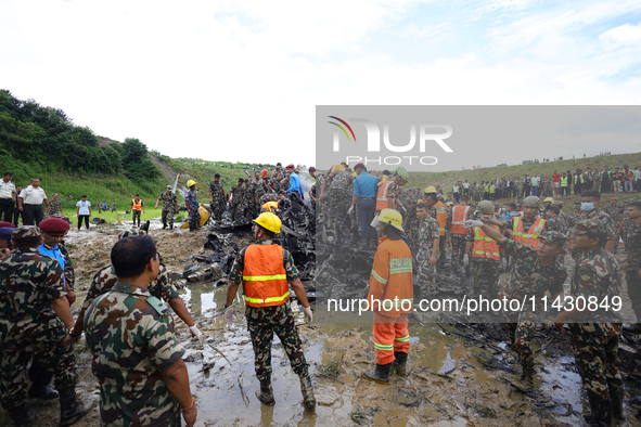 Rescuers from Nepal's security agencies are salvaging the remains of a passenger aircraft of Saurya Airlines that crashed at Tribhuvan Inter...