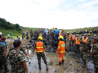 Rescuers from Nepal's security agencies are salvaging the remains of a passenger aircraft of Saurya Airlines that crashed at Tribhuvan Inter...