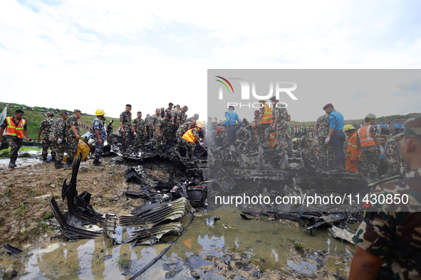 Rescuers from Nepal's security agencies are salvaging the remains of a passenger aircraft of Saurya Airlines that crashed at Tribhuvan Inter...