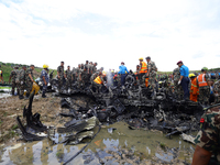 Rescuers from Nepal's security agencies are salvaging the remains of a passenger aircraft of Saurya Airlines that crashed at Tribhuvan Inter...