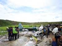 Rescuers from Nepal's security agencies are salvaging the remains of a passenger aircraft of Saurya Airlines that crashed at Tribhuvan Inter...