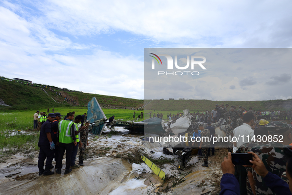 Rescuers from Nepal's security agencies are salvaging the remains of a passenger aircraft of Saurya Airlines that crashed at Tribhuvan Inter...