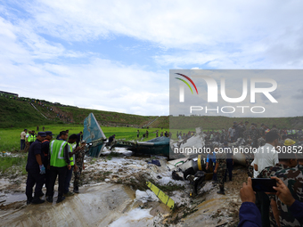 Rescuers from Nepal's security agencies are salvaging the remains of a passenger aircraft of Saurya Airlines that crashed at Tribhuvan Inter...