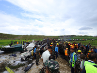 Rescuers from Nepal's security agencies are salvaging the remains of a passenger aircraft of Saurya Airlines that crashed at Tribhuvan Inter...