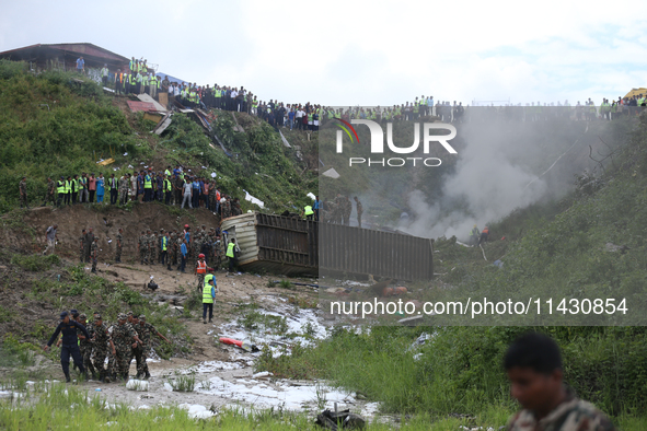 Rescuers from Nepal's security agencies are collecting the remains of a passenger aircraft of Saurya Airlines that crashed at Tribhuvan Inte...