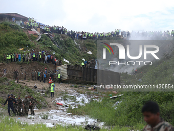 Rescuers from Nepal's security agencies are collecting the remains of a passenger aircraft of Saurya Airlines that crashed at Tribhuvan Inte...