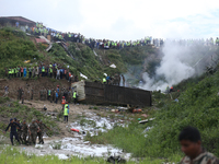 Rescuers from Nepal's security agencies are collecting the remains of a passenger aircraft of Saurya Airlines that crashed at Tribhuvan Inte...