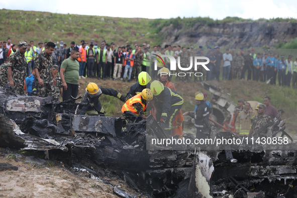 Rescuers from Nepal's security agencies are salvaging the remains of a passenger aircraft of Saurya Airlines that crashed at Tribhuvan Inter...