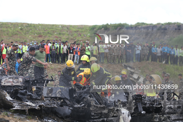 Rescuers from Nepal's security agencies are salvaging the remains of a passenger aircraft of Saurya Airlines that crashed at Tribhuvan Inter...