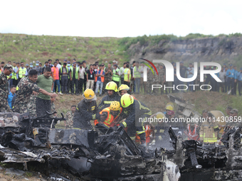 Rescuers from Nepal's security agencies are salvaging the remains of a passenger aircraft of Saurya Airlines that crashed at Tribhuvan Inter...