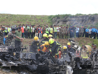 Rescuers from Nepal's security agencies are salvaging the remains of a passenger aircraft of Saurya Airlines that crashed at Tribhuvan Inter...