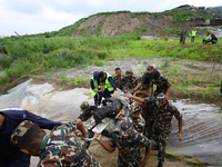 Rescuers from Nepal's security agencies are carrying charred bodies of a dead passenger retrieved from a passenger aircraft of Saurya Airlin...