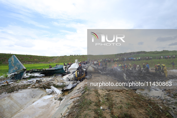 Rescuers from Nepal's security agencies are salvaging the remains of a passenger aircraft of Saurya Airlines that crashed at Tribhuvan Inter...