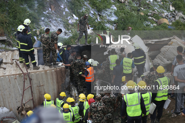 Rescuers from Nepal's security agencies are salvaging the remains of a passenger aircraft of Saurya Airlines that crashed at Tribhuvan Inter...