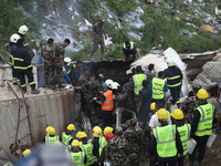 Rescuers from Nepal's security agencies are salvaging the remains of a passenger aircraft of Saurya Airlines that crashed at Tribhuvan Inter...